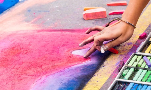 a person coloring with chalk