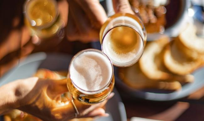 Bustling community with plenty of dining choices a group of people holding glasses with liquid in them