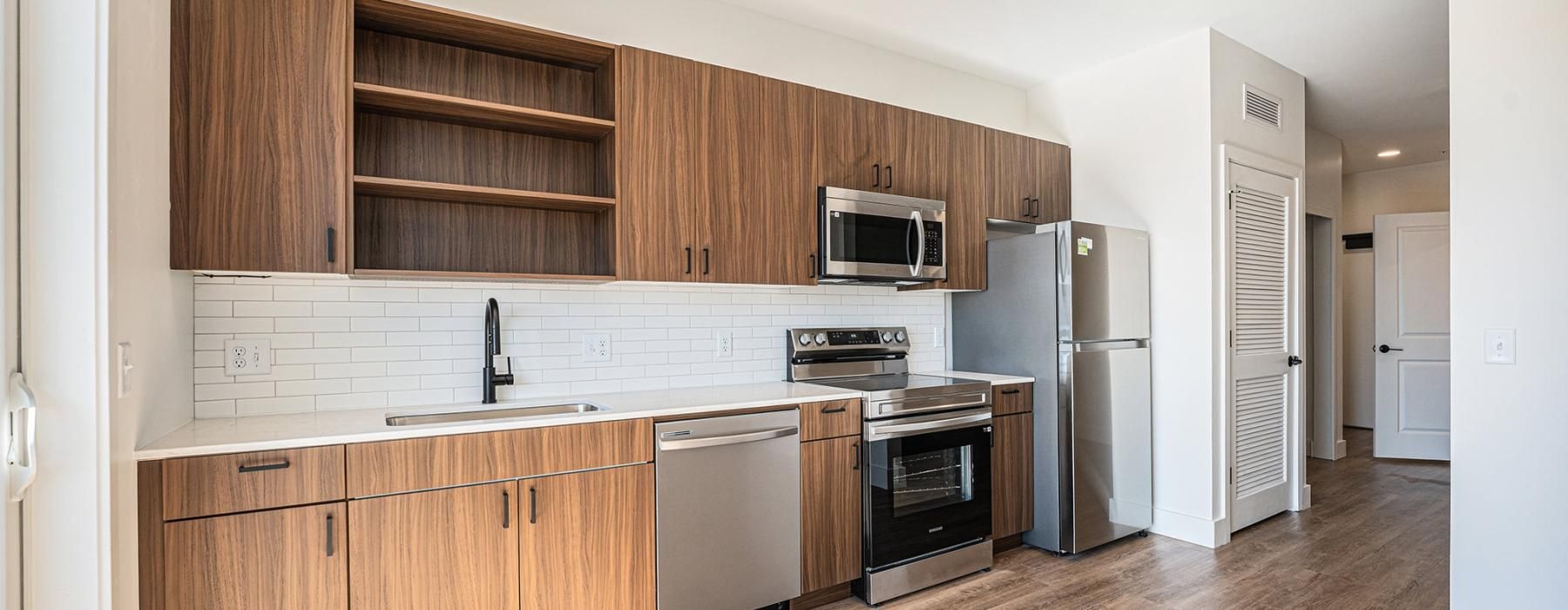 a kitchen with wooden cabinets